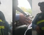 El agente de transito haciendo la ‘transacción’ con la conductora infractora. FOTO: Pantallazos video @leidysriveromartinez