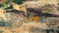 Una retroexcavadora, una motobomba y una draga pequeña escarban todavía entre la tierra malherida en busca de los últimos minerales que pueden quedar dentro de un enorme socavón de más de 20 metros de profundidad. Foto: MANUEL SALDARRIAGA QUINTERO.