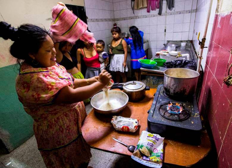 Mujeres cocinan al interior de los inquilinatos. Hay pocos fogones para la cantidad de inquilinos. Preparan plátano, arroz y huevos por turnos. 