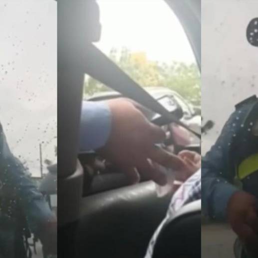 El agente de transito haciendo la ‘transacción’ con la conductora infractora. FOTO: Pantallazos video @leidysriveromartinez