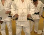 En la imagen, Juan Diego Calle, con su certificado de cinturón negro primer dan en judo. FOTO cortesía liga Antioqueña de judo
