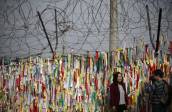 Otra parte de la cerca de alambre de púas aparece decorada con las banderas nacionales de Corea del Norte y Corea del Sur, cerca de la zona desmilitarizada, una franja de seguridad que protege el límite territorial de tregua entre las repúblicas coreanas, establecido en 1953. Mide 4 km de ancho y 238 km de longitud. FOTO REUTERS